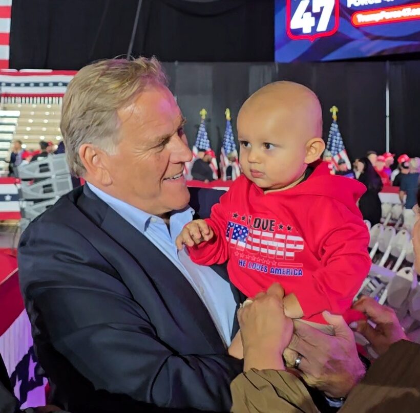 Mike Rogers holding a child at a Michigan campaign event