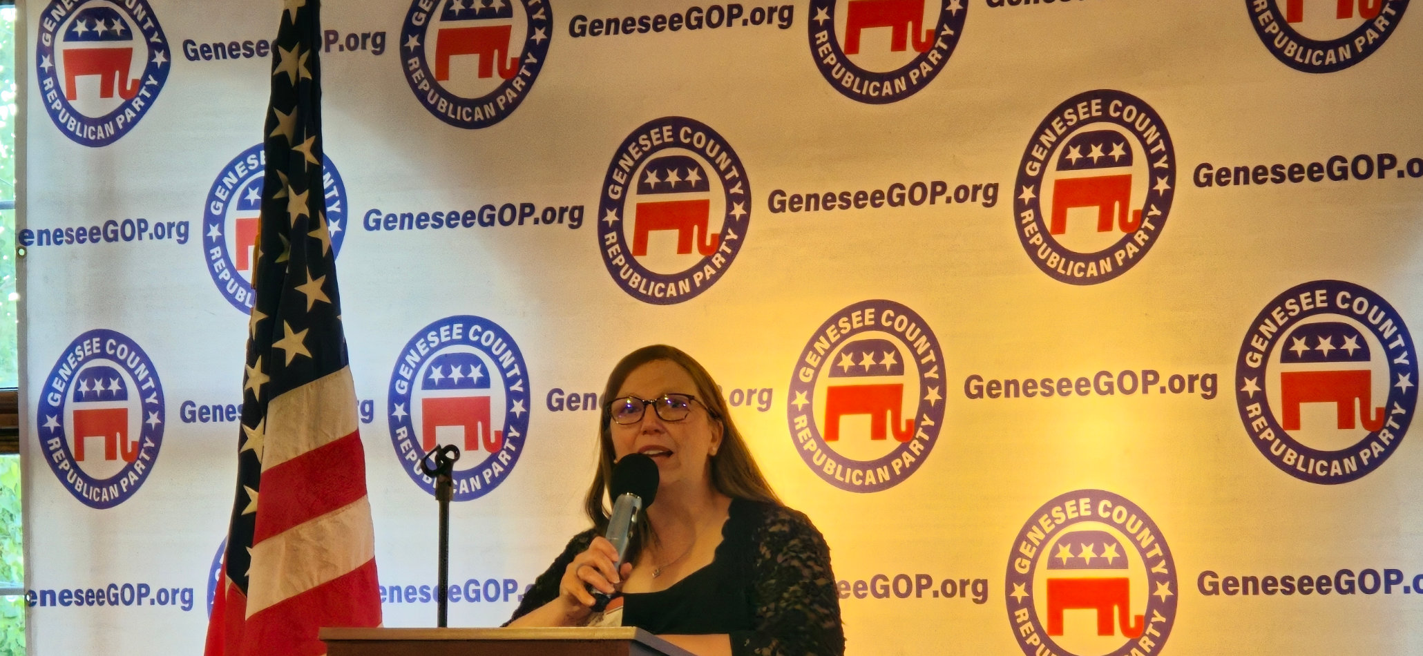 Genesee GOP Board Member Anne DeLisle on stage
