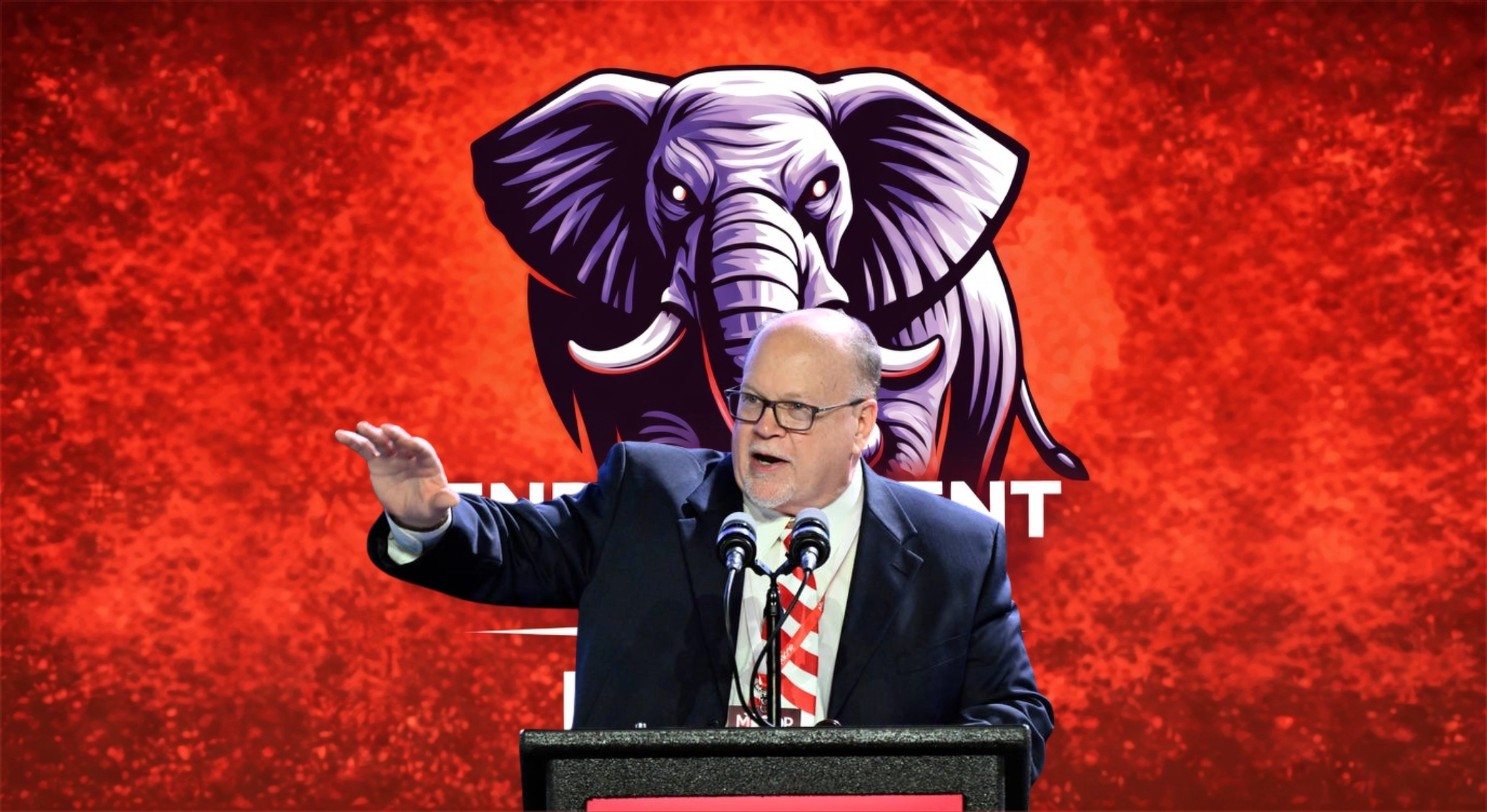 Michigan Republican Party Chair Jim Runestad speaking on stage at the 2026 MIGOP endorsement convention in Novi