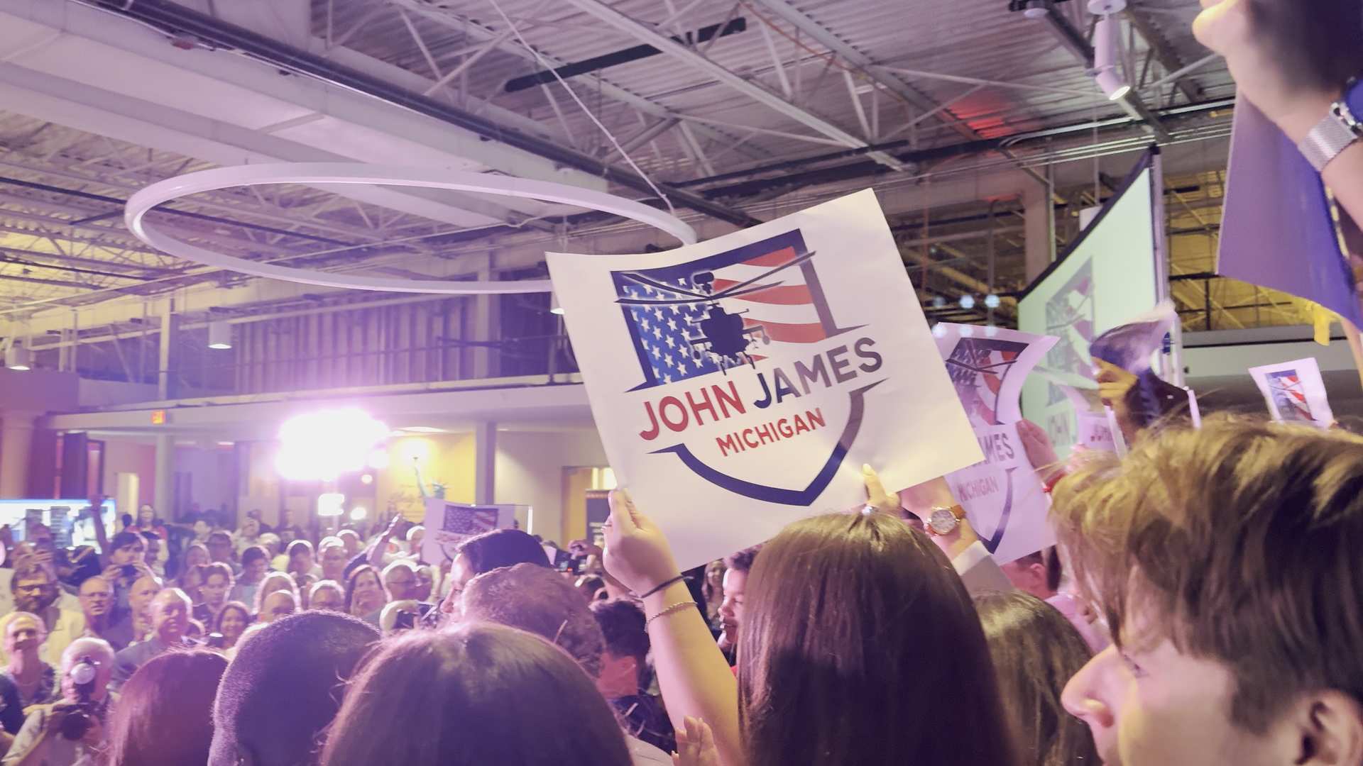 Crowd holding John James signs on primary night