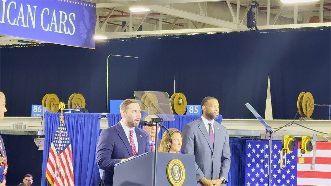 Michael Bouchard on stage with President Donald Trump at the July 27, 2026 Milford event at GM's proving grounds.