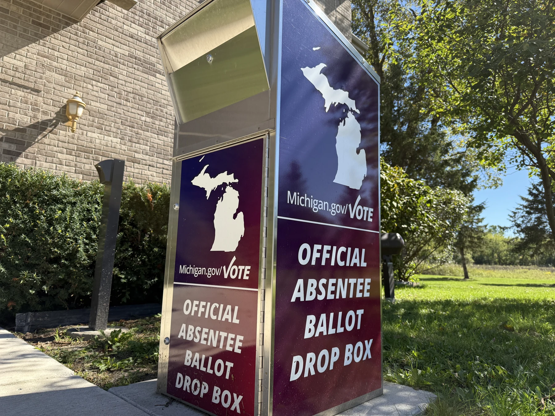 The Michigan outline and official absentee ballot drop-box lettering on the box’s front and side.