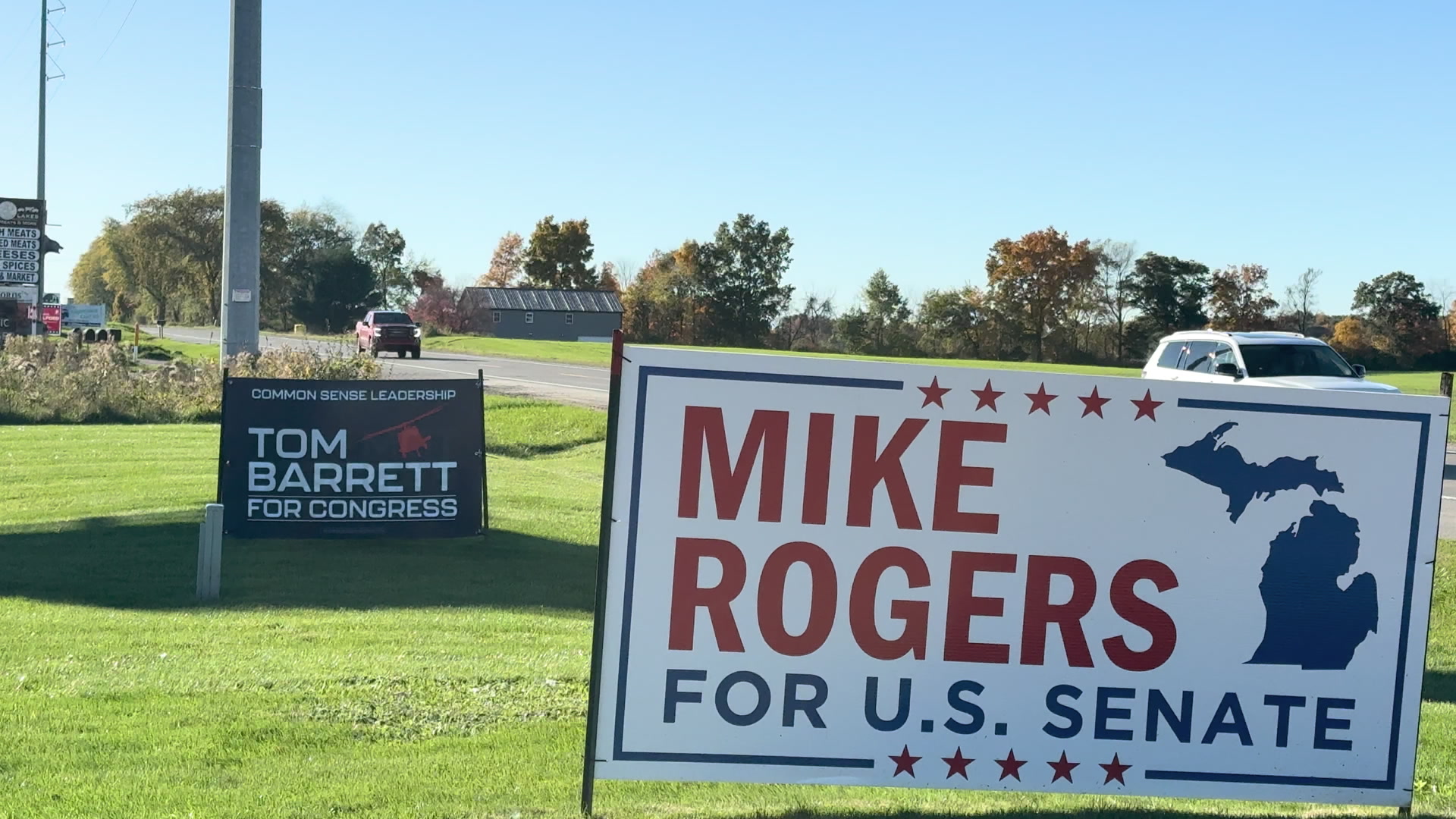 Campaign signs beside a Livingston County road in autumn