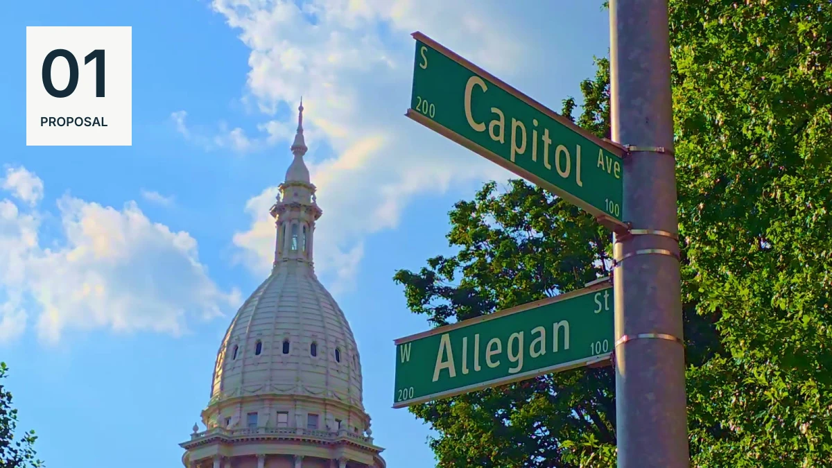 Michigan Capitol dome beside Capitol Avenue and West Allegan Street signs in Lansing.